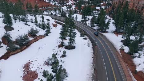 Driving-On-The-Road-Through-Snowy-Hoodoos-Of-Bryce-Canyon-National-Park-In-Utah,-USA-During-Winter