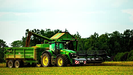 Timelapse-of-harvester-filling-loading-truck-with-fresh-corn
