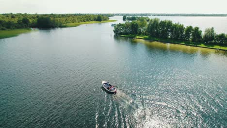 Aerial-view-orbiting-small-boat-on-lake-in-The-Netherlands