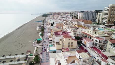Aerial-flyover-of-La-Carihuela-beach-and-seaside-resort-town