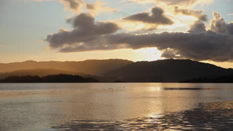 Peaceful-evening-on-shore-of-Raunefjorden-Sea-near-Bergen-in-Norway-at-sunset