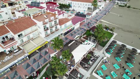 Aerial-view-orbiting-promenade-at-La-Carihuela-Beach,-Spain