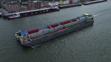 Container-Barge-carrying-liquid-Hydrogen-nearing-Dordrecht-port,-aerial
