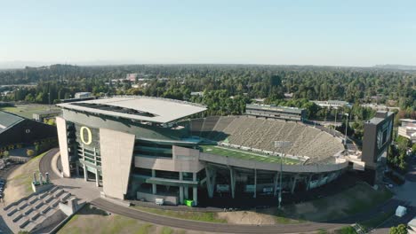 A-drone-rises-over-the-Autzen-Stadium-at-the-University-of-Oregon-football-arena-in-Eugene,-Oregon