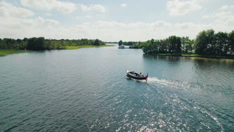 Low-angle-aerial-view-of-small-boat-on-lake-in-The-Netherlands