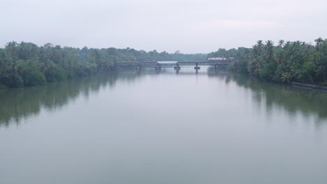 indian-railway-train-moving-very-slowlyon-a-bridge-over-the-river-in-kerala