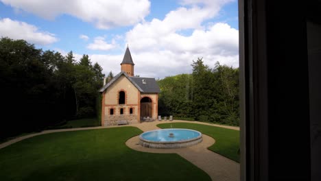 Slow-revealing-shot-of-a-renovated-church-with-a-beautiful-garden-and-fountain