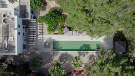 Top-Down-View-Of-Swimming-Pool-In-A-Private-Resort-In-Ibiza---drone-shot