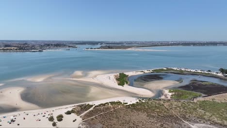 Drone-shot-of-a-beach-delta-by-river-Tejo,-Barreiro-in-Portugal