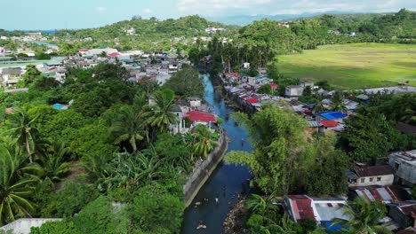 Flying-Over-Settlements-By-The-River-In-The-Province-Of-Legazpi,-Albay-In-The-Philippines