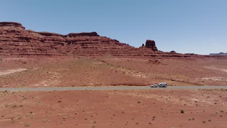 Car-with-a-trailer-driving-over-the-State-Route-95,-Hite,-Utah