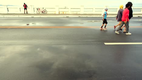 People-doing-fitness-on-wide-coastal-roads-without-any-vehicle