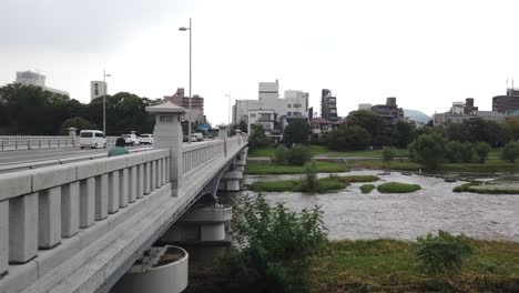 Bridge-Crossing-Along-Kamo-River,-Kyoto-City-Japan-in-Summer,-Urban-Park-Landmark
