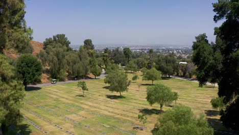 Wide-rising-aerial-shot-of-a-burial-lawn-with-rows-of-headstones-at-a-mortuary-in-California