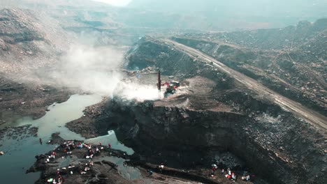 coal-mining-with-heavy-duty-machinery,-Dhanbad,-India,-spinning-aerial-shot