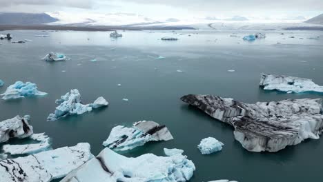 Aerial-view-from-Jokulsarlon-glacier-lagoon-in-Iceland-during-time-with-free-flowing-icebergs-composed-of-ice-that-is-over-1000-years-old