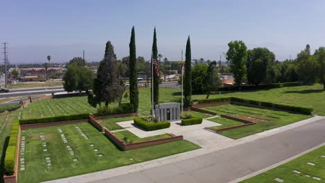 Low-aerial-dolly-shot-of-a-Veteran's-Memorial-at-a-mortuary-in-California