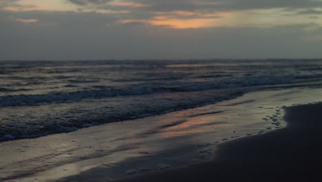 Serene-shot-of-rhythmic-waves-ron-golden-sands-of-the-beach-during-golden-hour