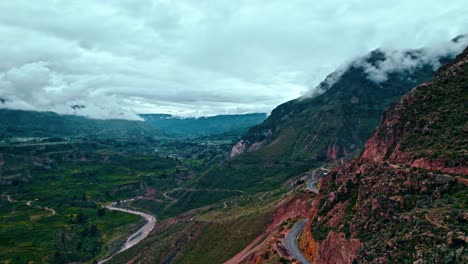Epic-drone-flight-over-Colca-Valley,-main-road,-cloudy-day,-Maca-village,-and-the-majestic-Colca-River