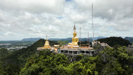 Golden-Buddha-Statue-on-Mountain-Top-Overlooking-Krabi,-Tiger-Cave-Temple,-Wat-Tham-Suea