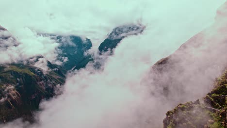 Dramatic-drone-flight-unveils-Colca-Canyon's-depth-amid-post-rain-clouds