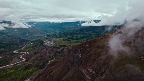Drone-reveals-Maca-village,-passing-Pachamarca-mountain,-with-Chivay-in-the-background