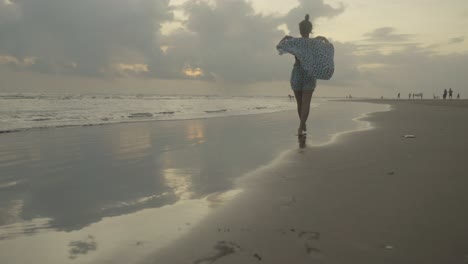 An-Indian-woman's-legs-as-she-strolls-along-the-beach