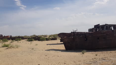 Abandoned-Rusty-Ships-and-Boats-in-Sand,-Former-Aral-Sea-Natural-Catastrophe,-Central-Asia