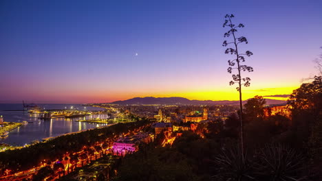 Crescent-moon-from-sunset-to-nighttime-over-the-Port-of-Malaga,-Spain---time-lapse