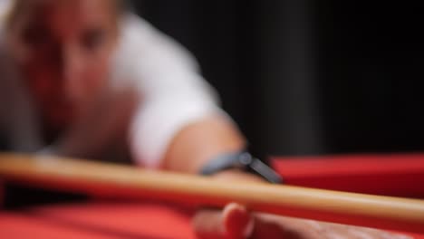 Woman-With-Pool-Billiard-Cue-Stick-On-Red-Pool-Table