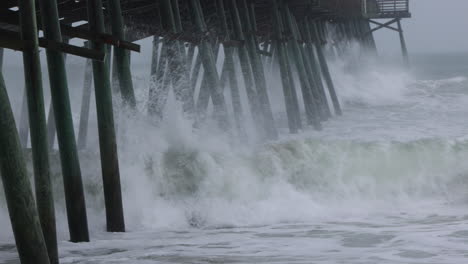 Hurricane-waves-crashing-into-pier-in-slow-motion,-tight-shot