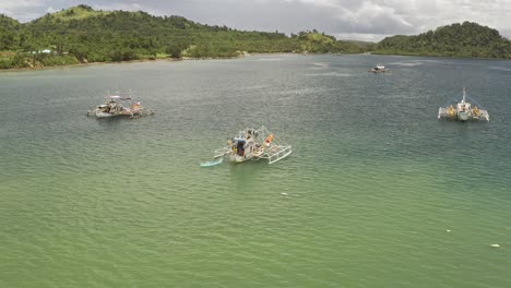 Fishing-Trawlers-Off-the-Coastal-Lush-Hillside-Landscape-in-the-Philippines-with-Turquoise-Waters-near-Surigao