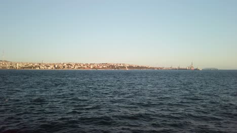 Evening,-cinematic-slow-mo,-the-view-of-Istanbul-Camlica-from-a-ferry-sailing-along-the-Bosphorus