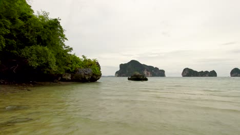 Low-Aerial-Dolly-Shot-Over-a-Coastal-Beach-on-the-island-of-Koh-Pakbia,-Krabi-in-Thailand