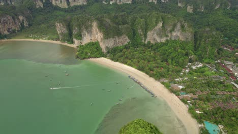 Railay-Beach-with-Turquoise-Waters-and-Limestone-Rocky-Cliffs-Surrounding-Tropical-Paradise-in-Thailand