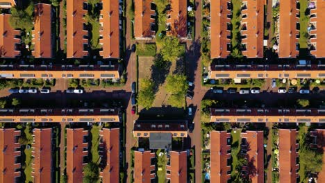 Symmetric-descending-shot-of-Dutch-orange-rooftops-in-village-district
