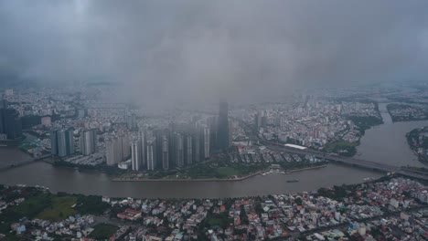Ho-Chi-Minh-City-hyperlapse-aerial-view-of-Landmark-building,-Saigon-River,-dramatic-sky-during-the-day-and-boat-traffic-on-water