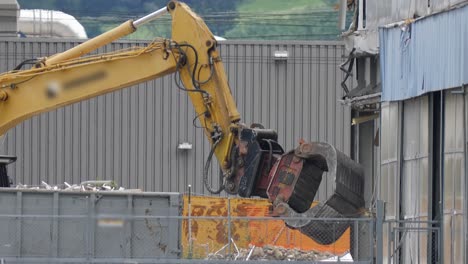 Excavator-With-Hydraulic-Claw-Dismantling-Large-Building-In-Switzerland