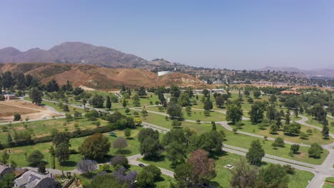 Aerial-super-wide-reverse-pullback-shot-of-the-manicured-grounds-of-a-mortuary-in-Southern-California