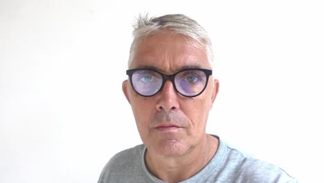 White-middle-age-male-looking-intense-removes-his-glasses