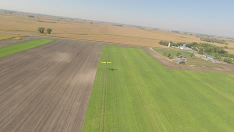 Low-Level-Flight-of-Small-Crop-Duster-Plane-Captured-by-FPV-Drone-at-Rural-Grass-Airstrip
