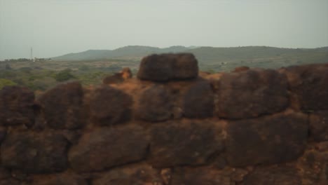 Panoramic-View-over-the-bricks-of-the-Ruins-of-an-Old-Coastal-Fortress-and-an-Ocean-Horizon
