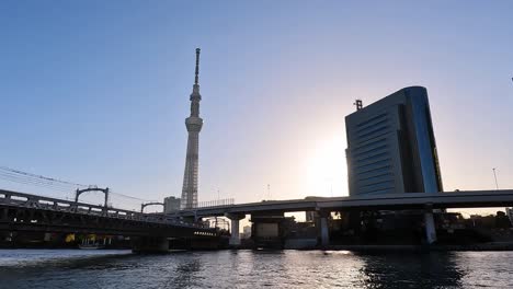 Tokyo-Skytree-cityscape-with-beautiful-blue-sky-day-at-dusk-with-the-Sumida-river