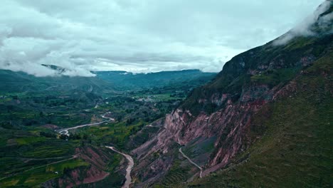 Drone-flight-over-Colca-Valley,-Peñablanca-mountain-to-the-right,-cloudy-day-after-rain,-views-of-Maca-village,-and-Colca-Rive