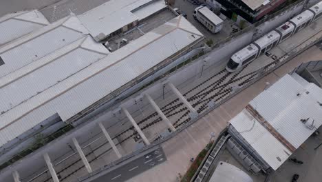 Aerial-drone-view-of-metro-arriving-at-Elifelet-metro-station-in-Tel-Aviv