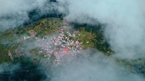 Drone-pans-left-to-right,-revealing-Tapay-village-lost-amidst-clouds