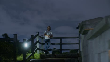 European-man-male-caucasian-white-model-posing-in-the-night-on-the-top-of-the-hill-and-ladder-with-long-hair