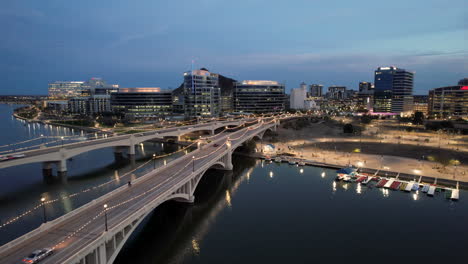 Tempe-Salt-River-Twilight-with-Aerial-Drone-Push-In-Over-Bridges-with-City-Skyline-View-in-Arizona,-USA