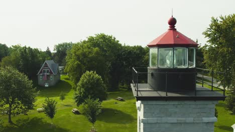 Drone-shot-passing-the-huge-light-and-lenses-of-the-light-houses-and-museum-at-Sodus-point-New-York-vacation-spot-at-the-tip-of-land-on-the-banks-of-Lake-Ontario