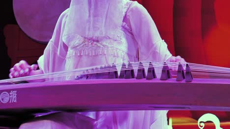 A-girl-wearing-Sichuan-traditional-clothes-and-playing-Guqin-in-a-famous-Sichuan-culture-Opera-show